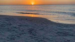 A beach with a sunset over the ocean, sandy shore, and a clear sky. - Beachfront 2BR/2Bath Condo on the Gulf, Indian Rocks Beach, Florida (Indian Rocks Beach)