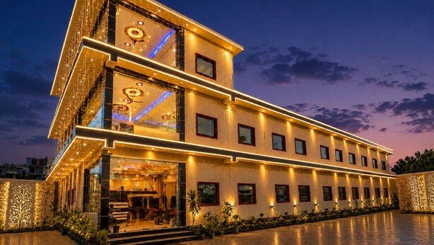 A multi-story hotel with a modern design, featuring a prominent entrance with steps and a reception area. - Shree Venkatesh Niliyam 300 M Ram Temple (Ayodhya)