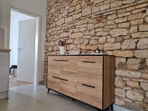A wooden dresser with drawers against a stone wall. - Casa Arena 1 min walk to the Colosseum, city centre and harbour promenade 3 min (Pula)
