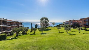 A hotel with a sea view, a large lawn, and a prominent tree in the center. - San Sivino 108 Lake View with Pool (Manerba del Garda)