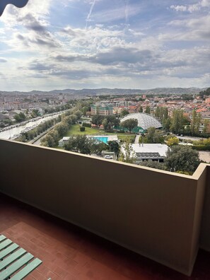 A balcony with a view of a cityscape, including a river, buildings, and a dome-shaped structure. - Waterfront apartment with breathtaking views in a very central location. (Pesaro)