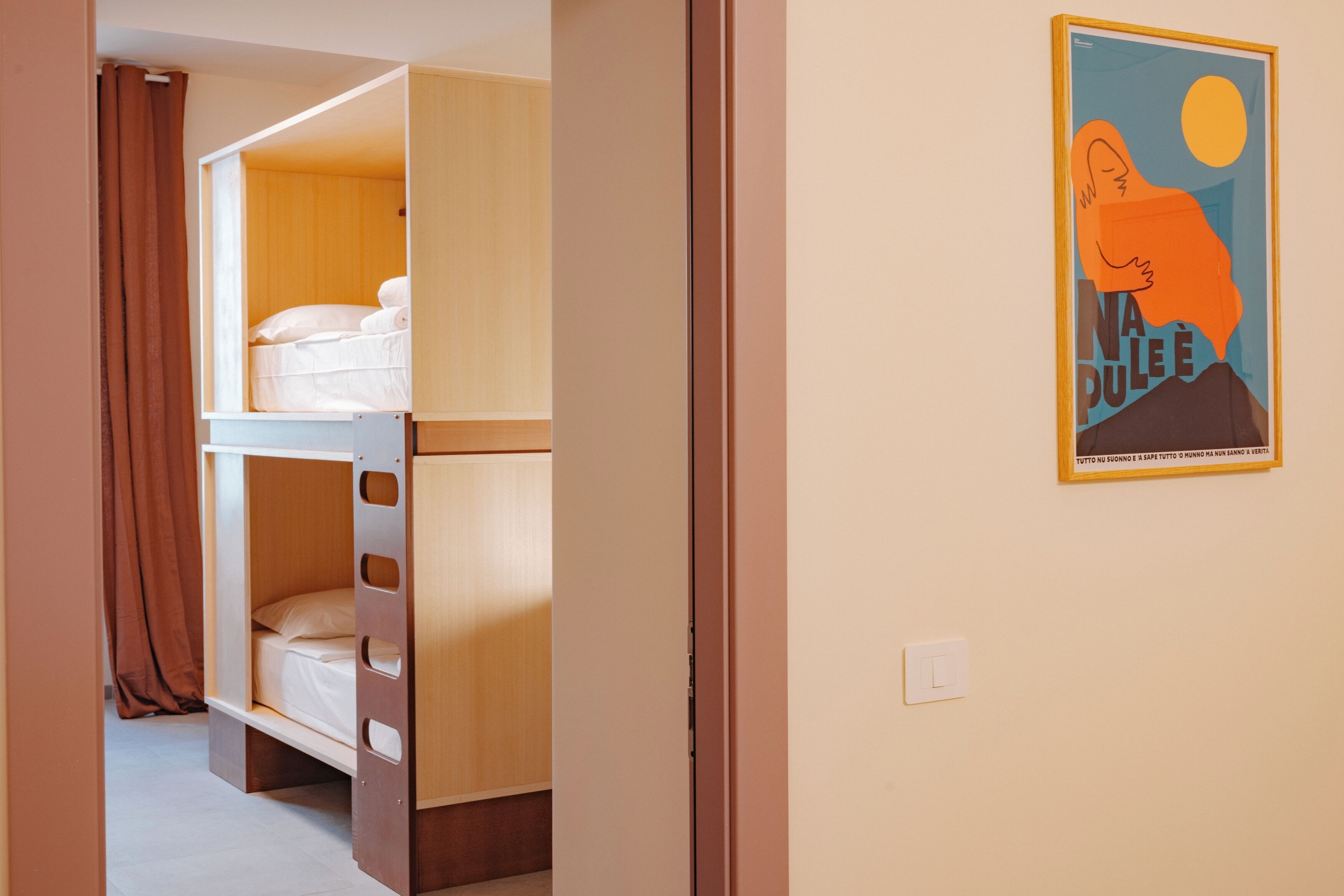 A bunk bed room with a poster on the wall.