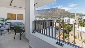 A balcony with a view of a cityscape and a mountain. - The York  | Designer CBD Gem | Spacious Balcony (Cape Town)