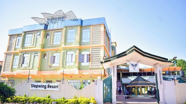 A multi-story hotel with a prominent entrance and a sign reading "Stepwing Resort." - Stepwing Resort (Nyeri)