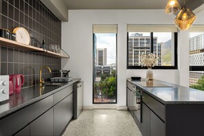Fridge, microwave, oven, stovetop - Designer CBD Retreat | Rooftop Pool + Deck (Cape Town)