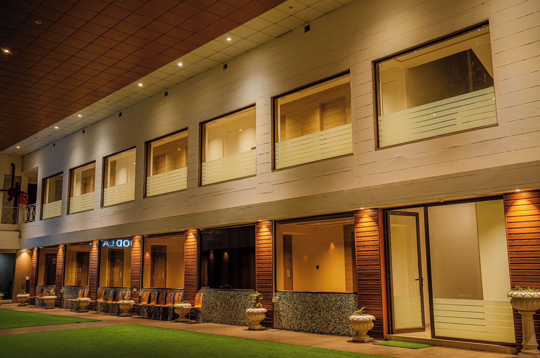 A hotel with a modern facade, large windows, and a well-lit entrance.