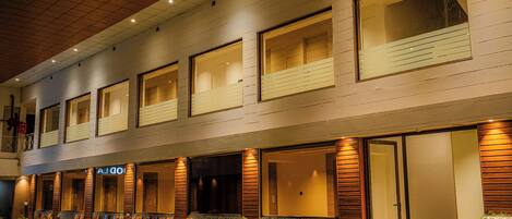 A hotel with a modern facade, large windows, and a well-lit entrance.