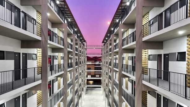 A multi-story hotel corridor with balconies, a central walkway, and a modern architectural design. - Apartment with balcony in Ferndale, Randburg. Stylish, secure and comfortable. (Randburg)