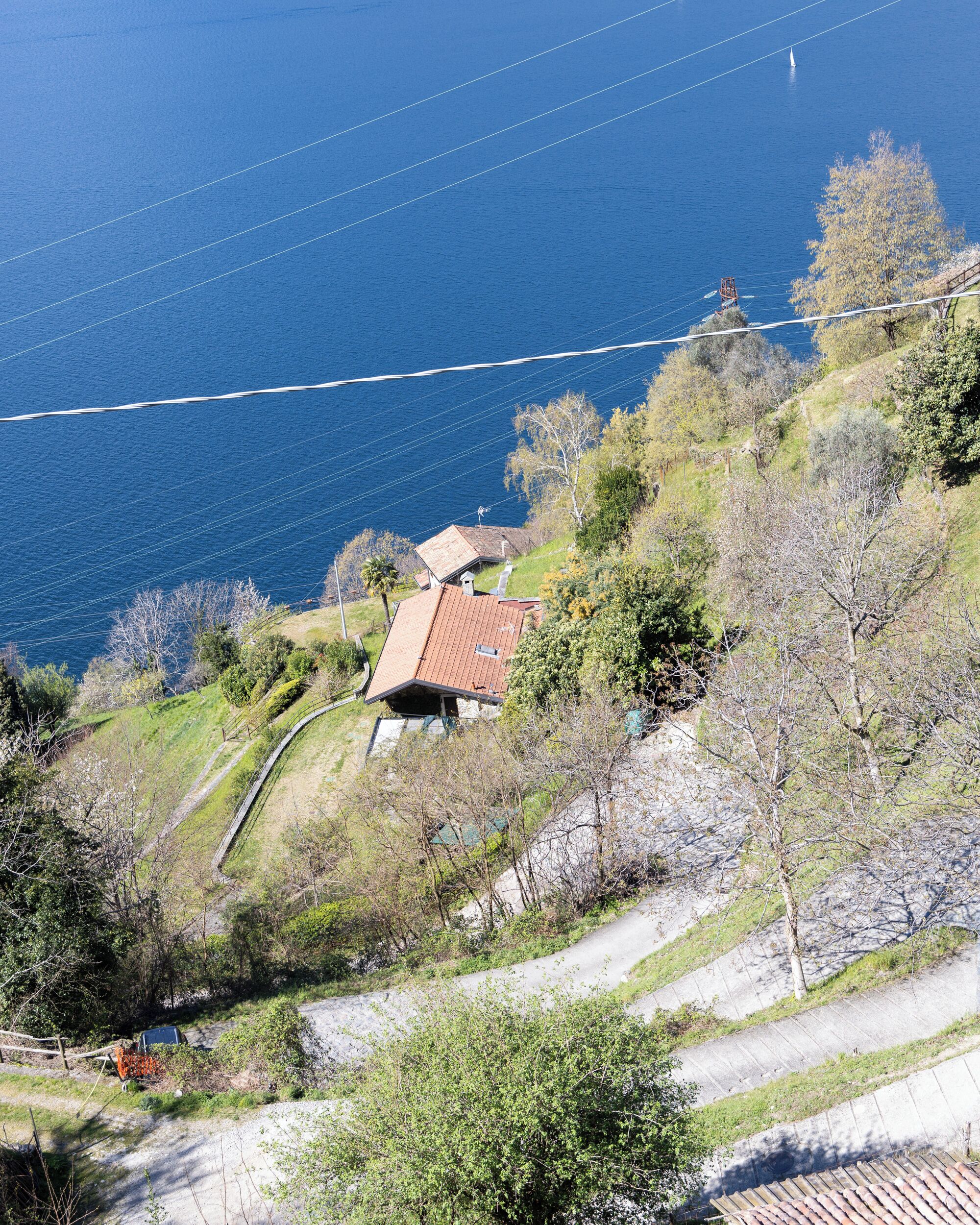 A coastal property with a house, a pathway, and a view of the sea.