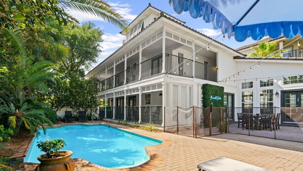 A two-story building with a swimming pool, outdoor seating, and a covered patio area. - Beach House · Private Beach · Private Pool & Backyard · Steps to Sand (Miramar Beach)