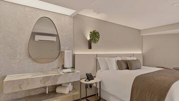 Une chambre d’hôtel moderne avec un grand lit, une coiffeuse intégrée avec un miroir, une petite table de chevet avec un téléphone et une plante en pot.