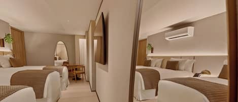 Una habitación de hotel con dos camas, un escritorio, una silla, un televisor y un aire acondicionado.