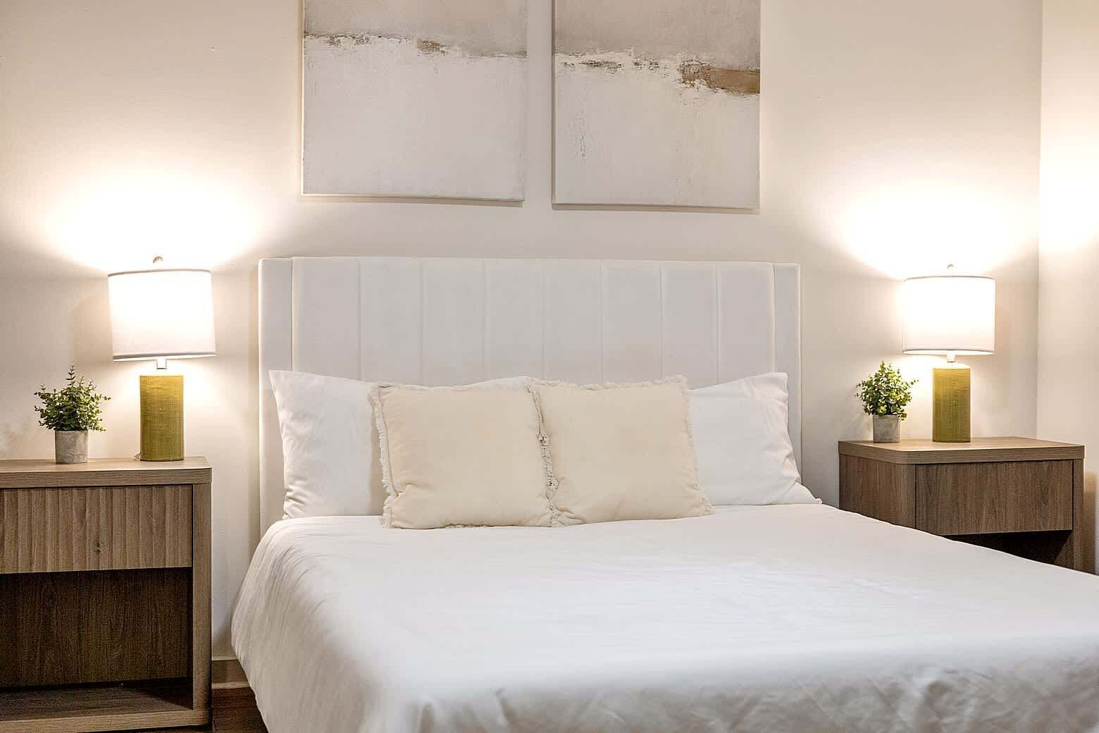Relaxing secondary bedroom with a plush bed, soft linens, and warm bedside lighting. Designed for comfort and rest, offering a peaceful atmosphere that feels inviting after a long day.