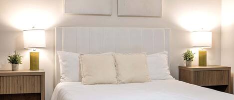 Relaxing secondary bedroom with a plush bed, soft linens, and warm bedside lighting. Designed for comfort and rest, offering a peaceful atmosphere that feels inviting after a long day.