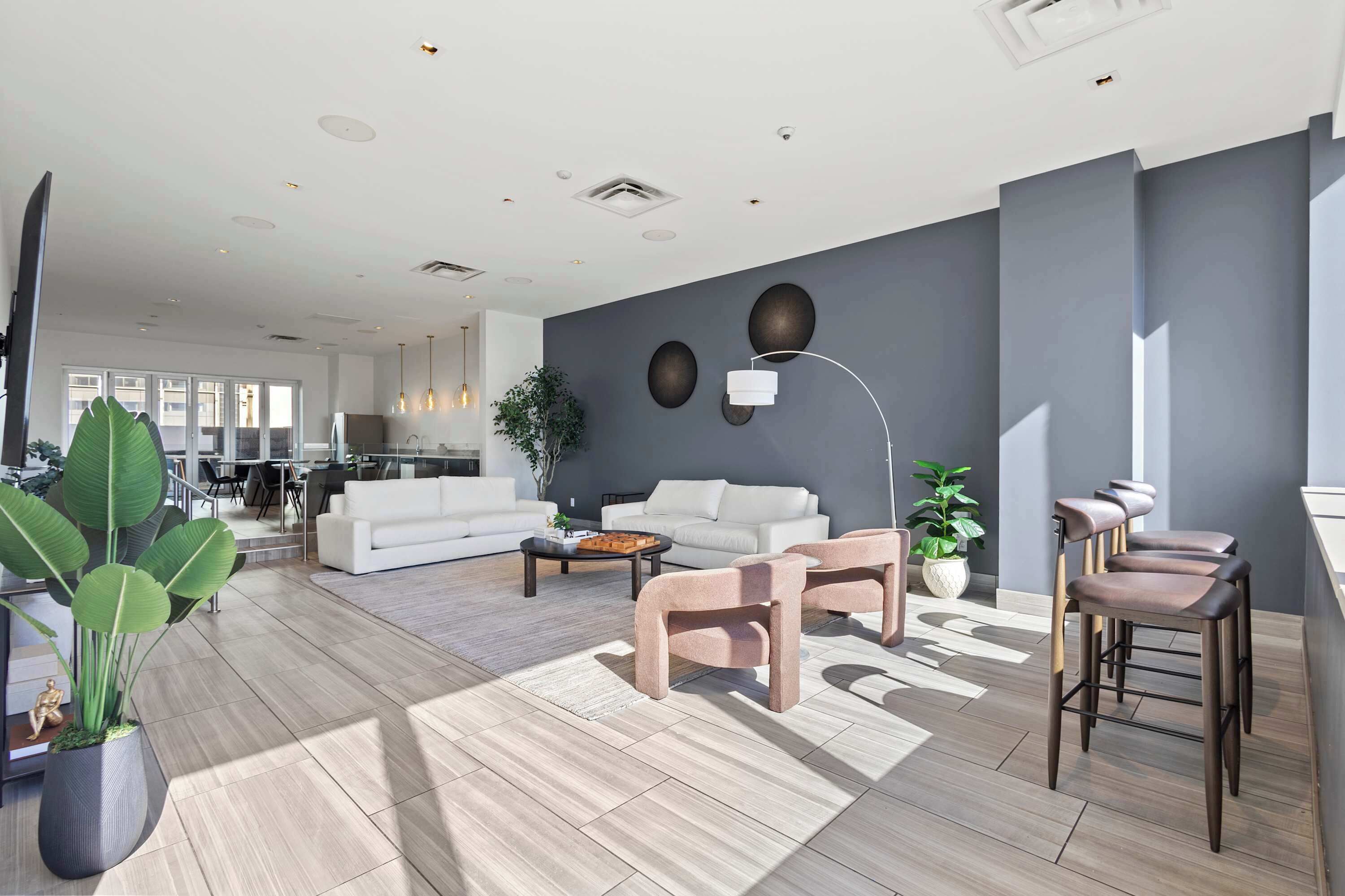 Shared event room inside the building featuring stylish seating, open layout, and natural light. A comfortable space for relaxing, casual gatherings, or enjoying time outside of the apartment.