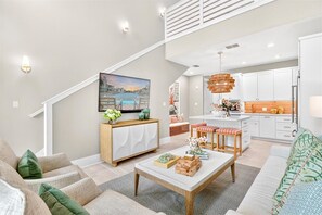 A modern living room with a sofa, coffee table, and a painting on the wall. - Lala Land TC 6302 (Port Aransas)