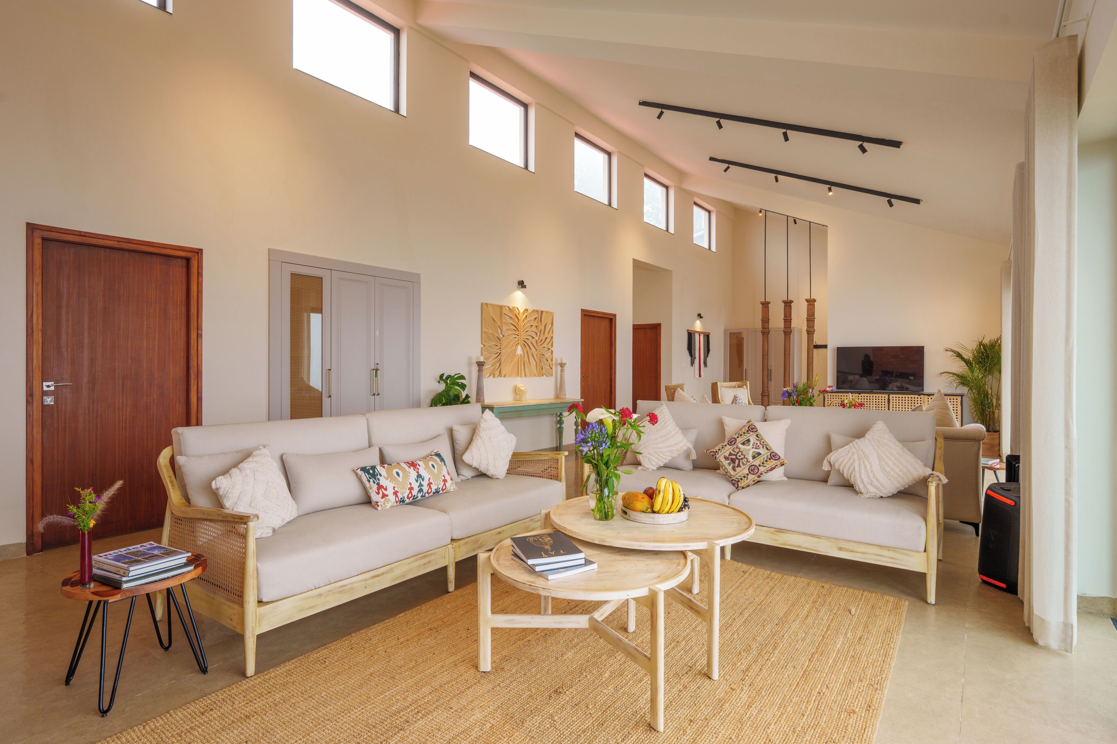 A spacious living area with two sofas, a coffee table, and a TV.