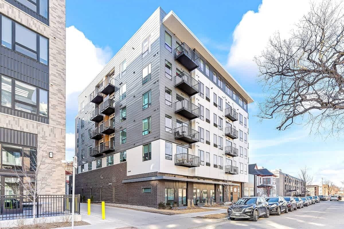 Contemporary six-story apartment complex showcasing stylish architecture with private balconies, modern paneling, and a vibrant urban neighborhood setting.