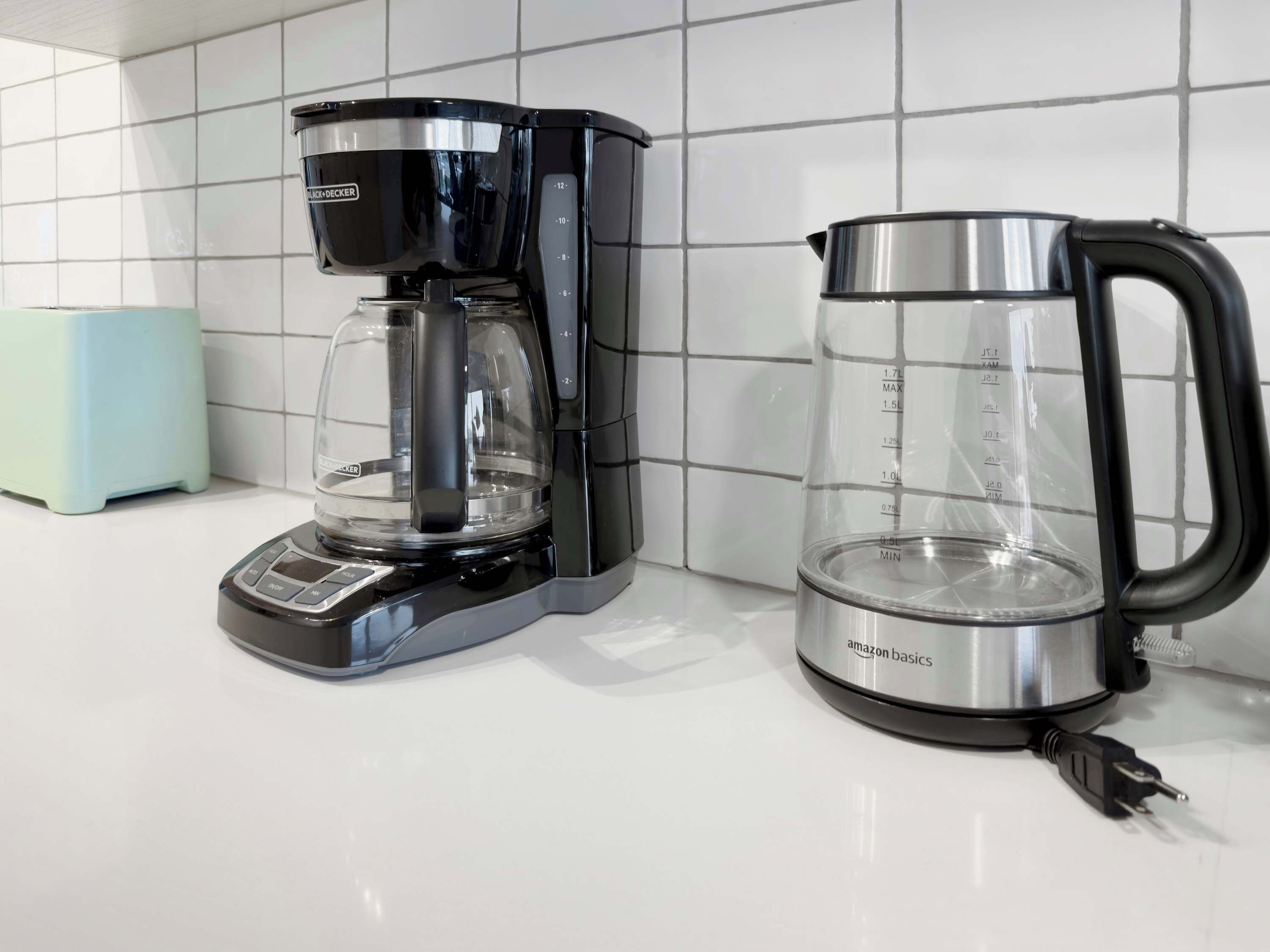 A coffee maker and a glass carafe on a kitchen counter.