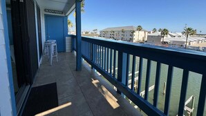 A balcony with a view of the marina and buildings.