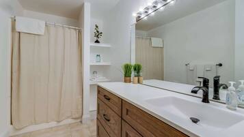 Shower, hair dryer, towels, shampoo