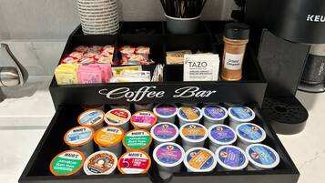 A coffee bar with a variety of coffee pods and a Keurig coffee machine.