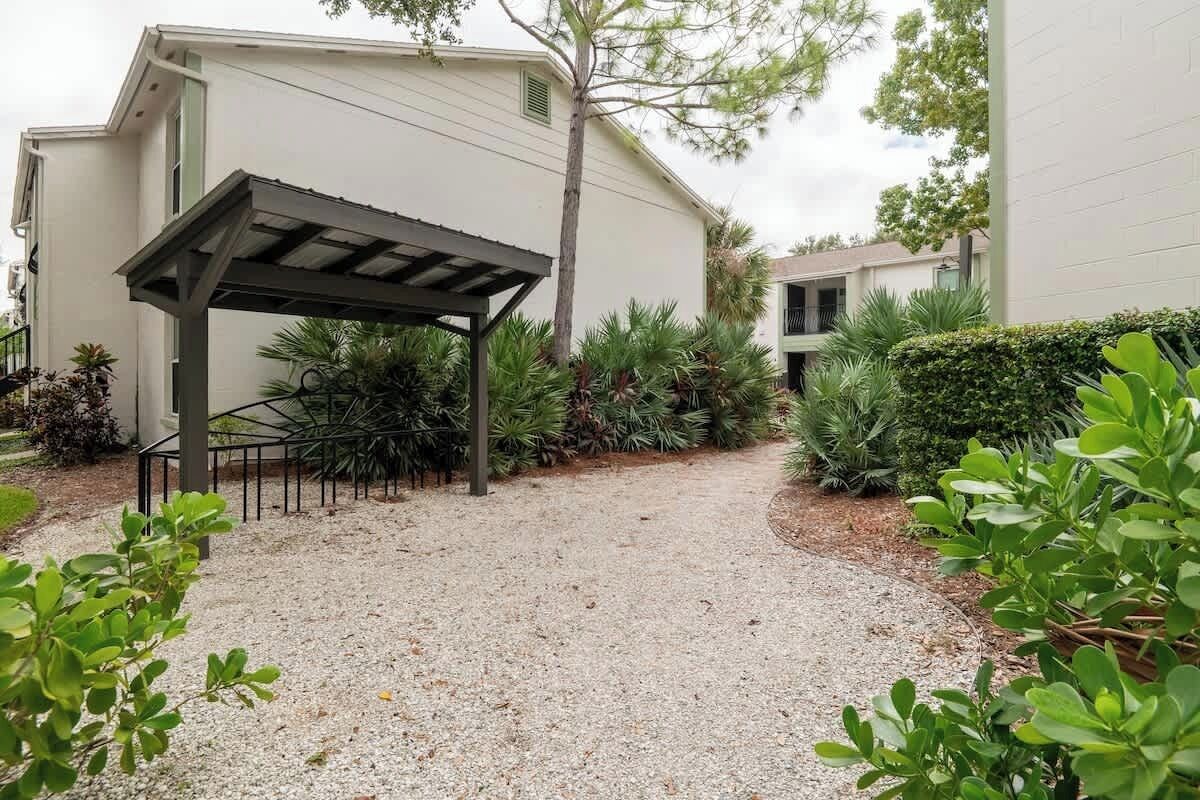Serene garden pathway surrounded by tropical greenery for a relaxing community stroll.