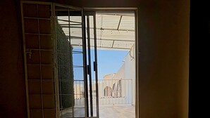 A bedroom with a sliding glass door leading to a balcony. - Casa Jardines SLW, an ideal house for families or companies! (Saltillo)