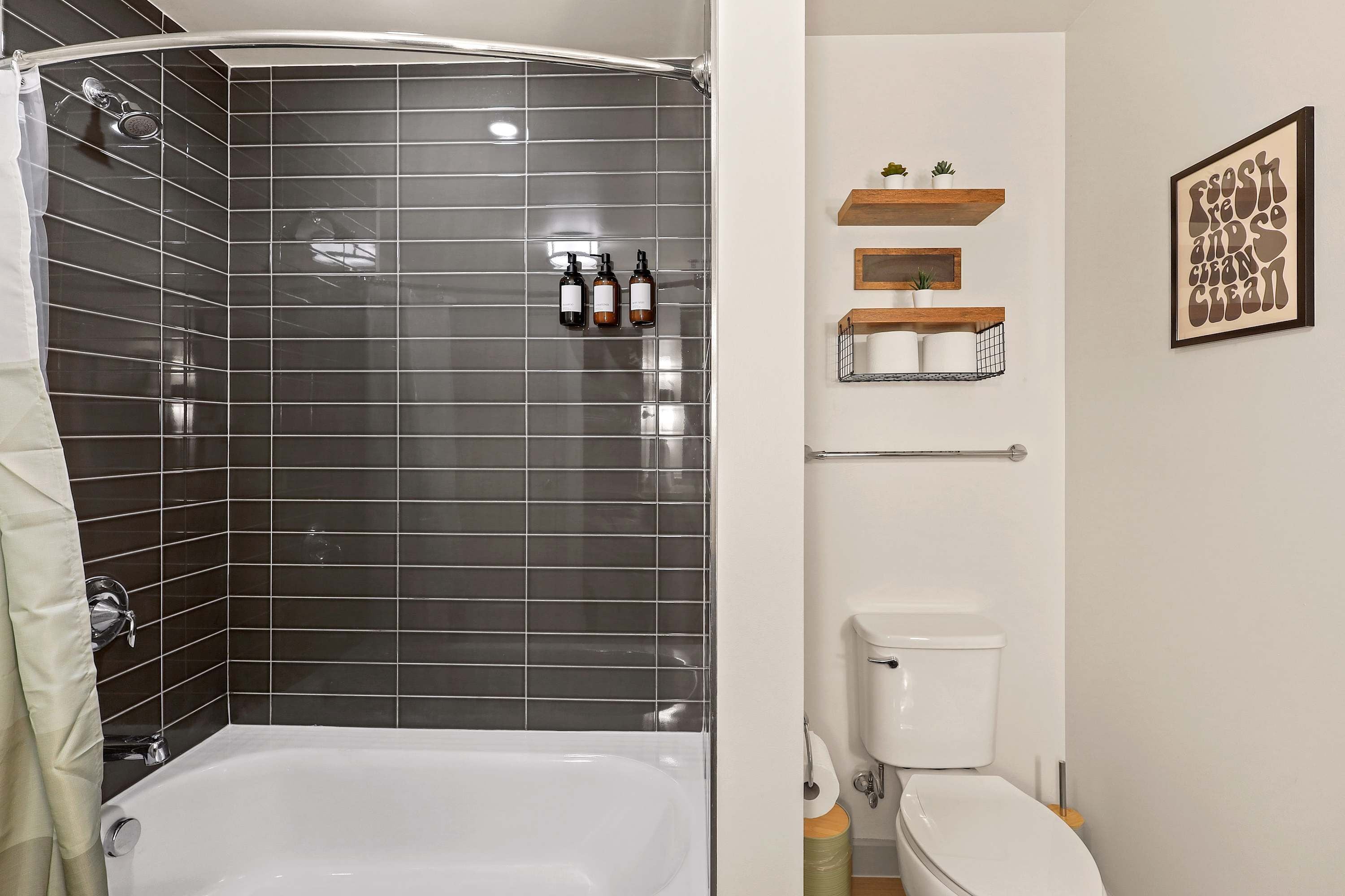 Refresh in a spotless tub-shower setup with mounted dispensers for shampoo, conditioner, and body wash.