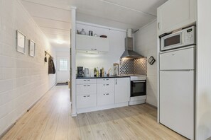 A kitchen with white cabinets, a microwave, and a dishwasher.