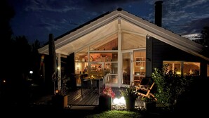 A modern house with a large glass extension, a deck, and outdoor seating. - Beautiful summer house from 2008 outdoor spa (Nakskov)
