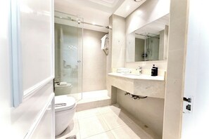 A bathroom with a toilet, a sink, a mirror, and a shower area. - Burj Khalifa View Luxury 2BR Apartment Souk Al Bahar Downtown Dubai (Dubai)