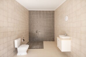 A bathroom with a toilet, sink, and shower. - Your private retreat with garden, terraces, and stunning sunset views. (Estoi)