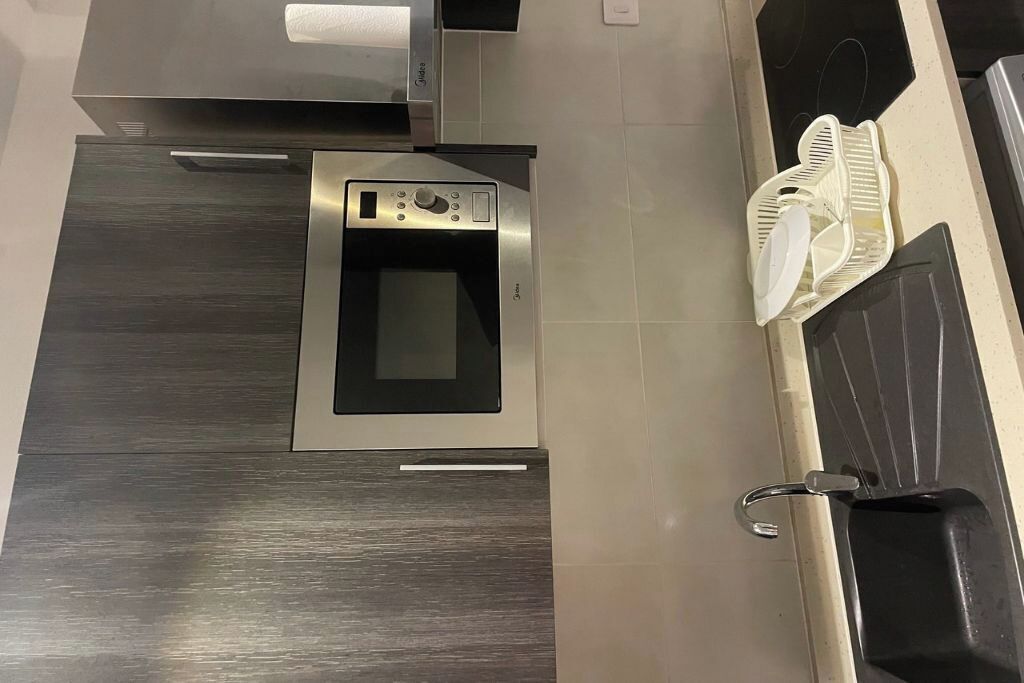 Luxury Studio Suite, Balcony, Pool View | Private kitchen | Full-size fridge, microwave, oven, stovetop