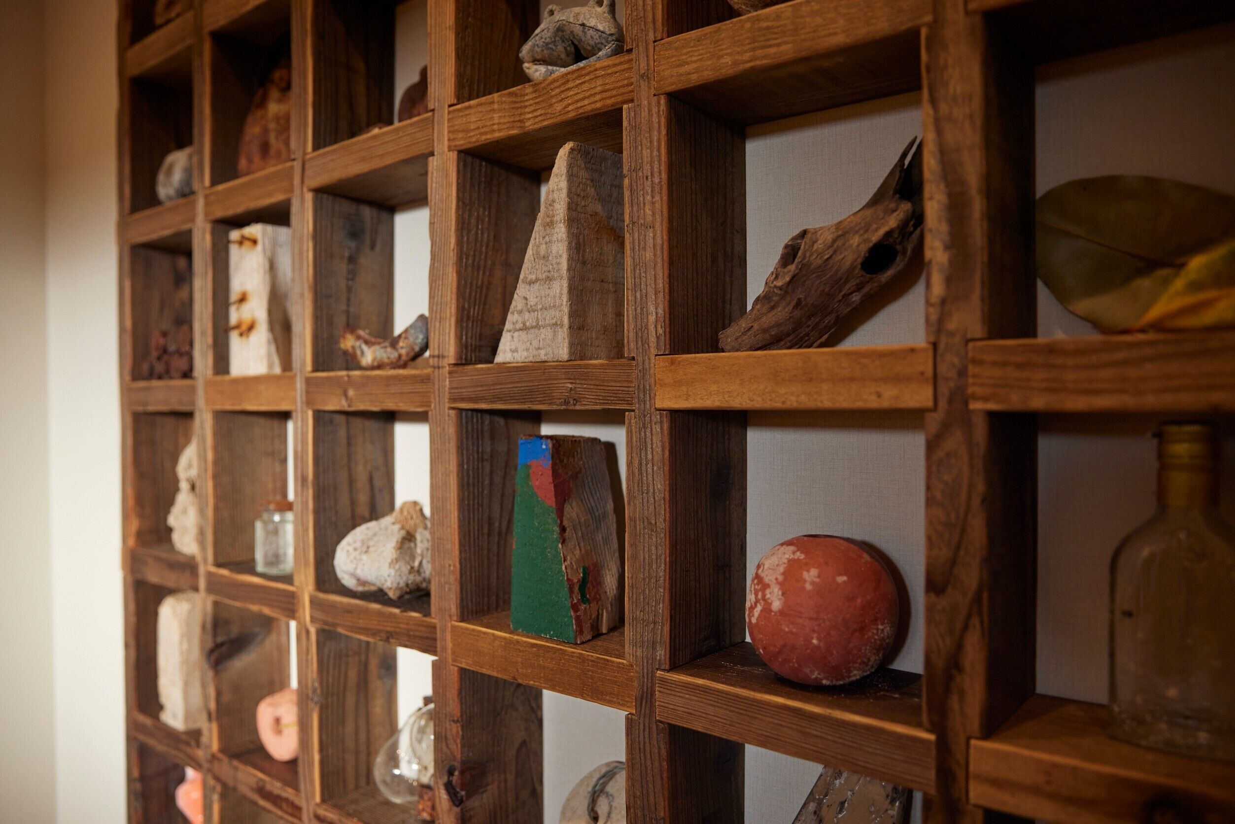 A wooden display shelf with various artifacts.