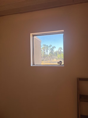 A small window with a view of palm trees and a clear sky. - Corner fairway & mountain view 3 BR+3.5 BA condo, chef's kitchen, private spa! (Rancho Mirage)