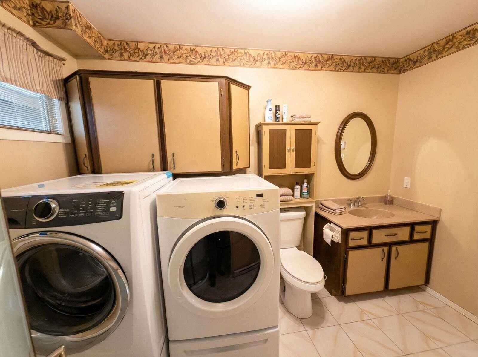 A compact bathroom with a washing machine, a toilet, and a sink.