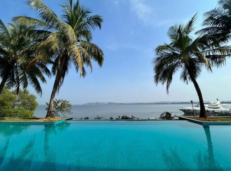 Outdoor pool. The Postcard on The Mandovi River
