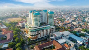 A multi-story hotel with a modern design, featuring a central courtyard and multiple balconies. - Horison Ultima Sentraland Semarang (Semarang)