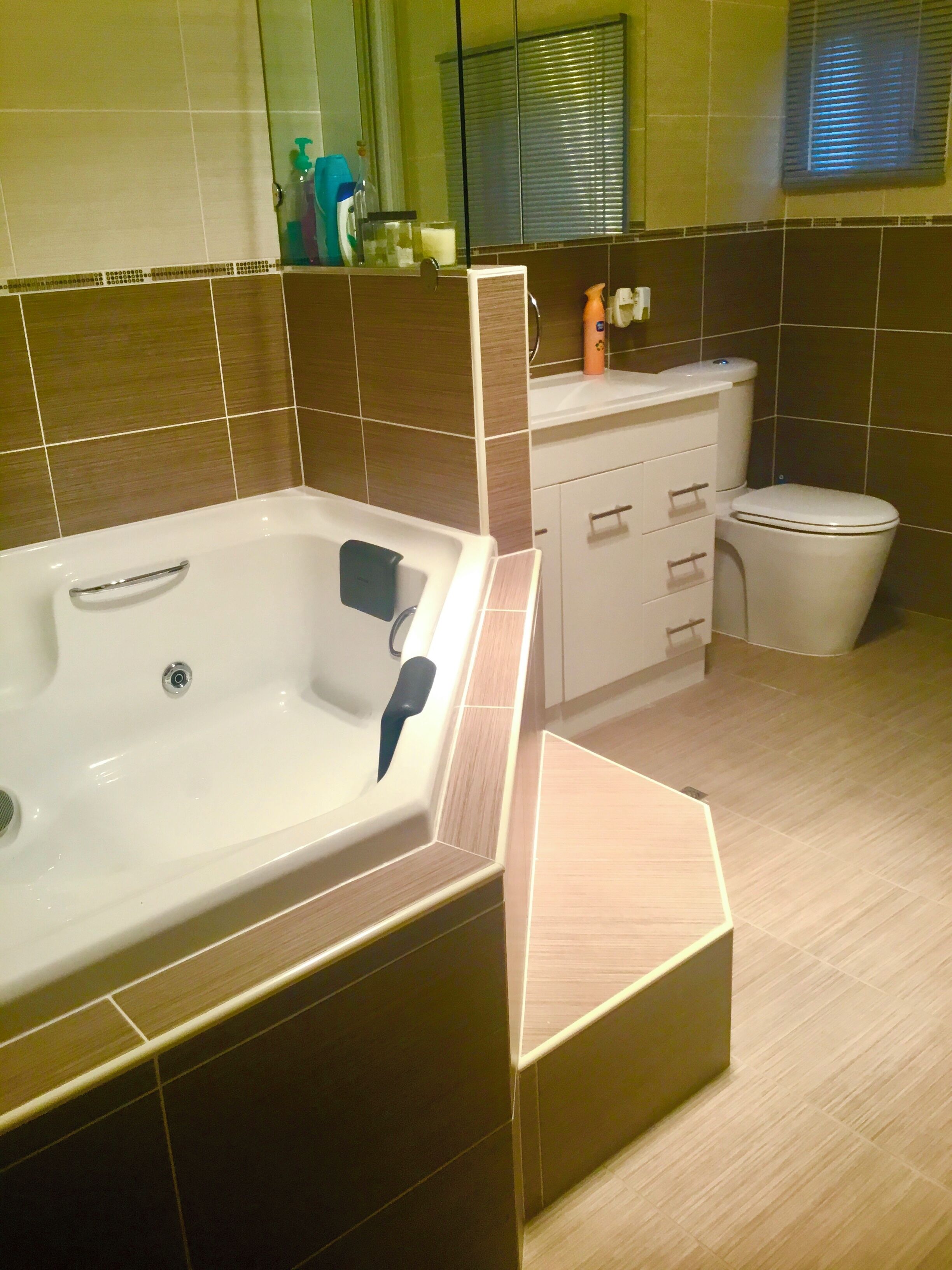 A modern bathroom with a bathtub, toilet, and sink.