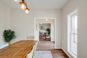 A spacious dining area with a wooden table and chairs, a hanging light fixture, and a view into another room with a desk and chair. - 6b/4.5b Pool w lake views, 3 acres, lake access (Buchanan Dam)