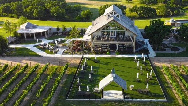 A vineyard with rows of grapevines, a large building with a sloped roof, and a patio area with outdoor seating. - Two Houses, POOL, shared backyard 8bed/4bath (Blanco)