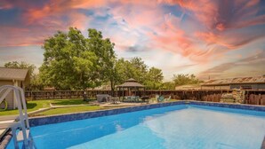 A swimming pool with a wooden deck, a gazebo, and a fenced yard. - Two Houses, POOL, shared backyard 8bed/4bath (Blanco)