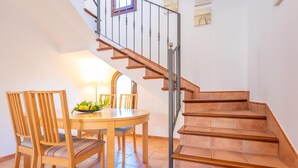 A staircase with wooden steps and metal railings, leading to an upper floor. - PUNTA LLARGA - Cozy house with sea views, private pool and free Wi-Fi (Artà)