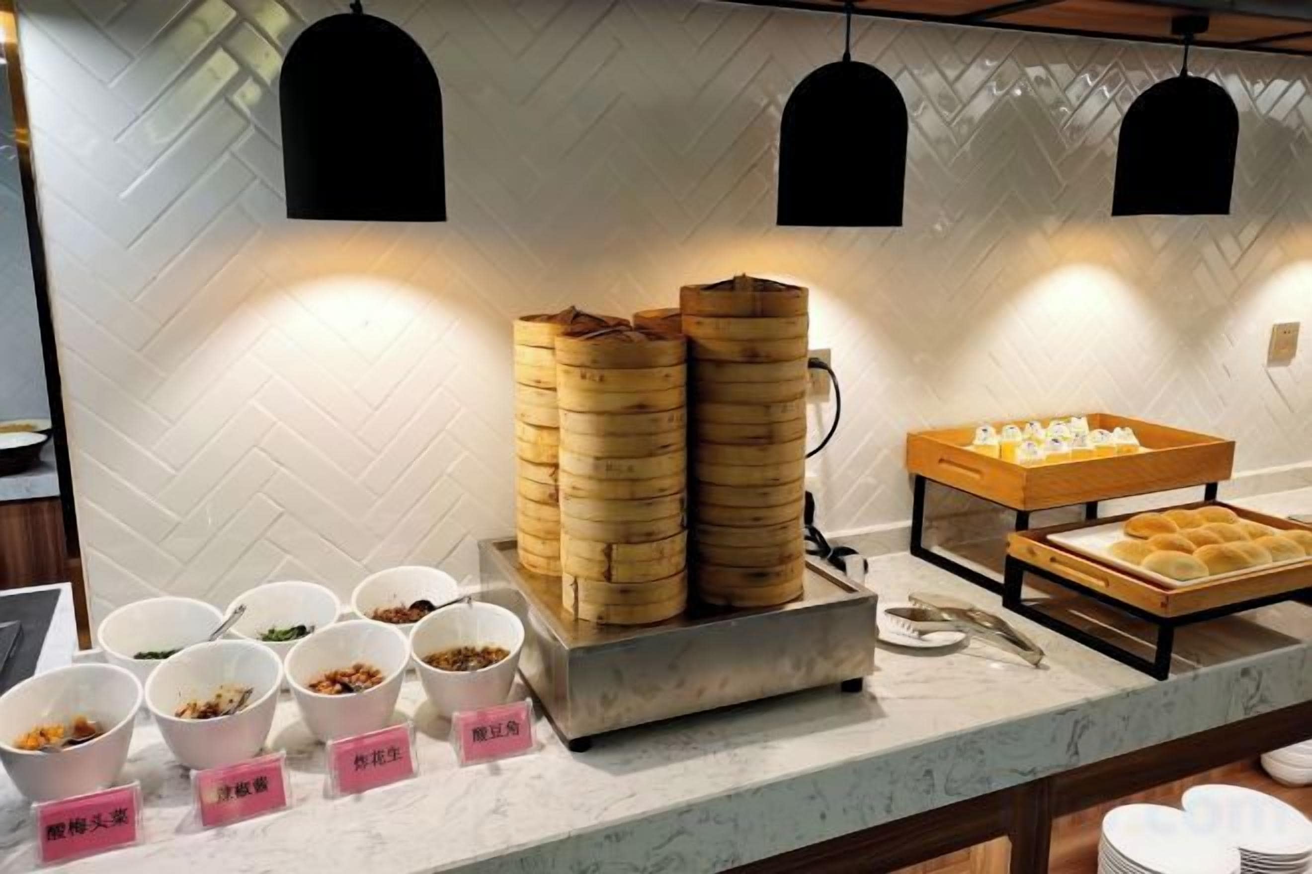 A buffet setup with various food items and containers.
