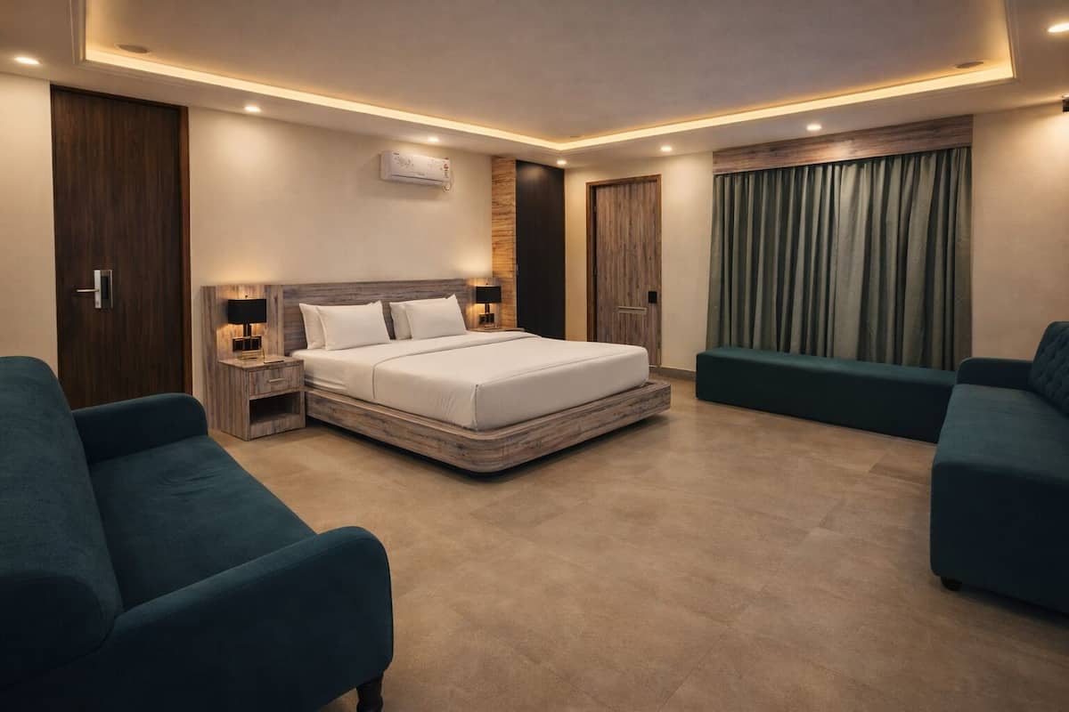 A modern hotel room with a large bed, two bedside tables, a wall-mounted air conditioner, and a large window with curtains.