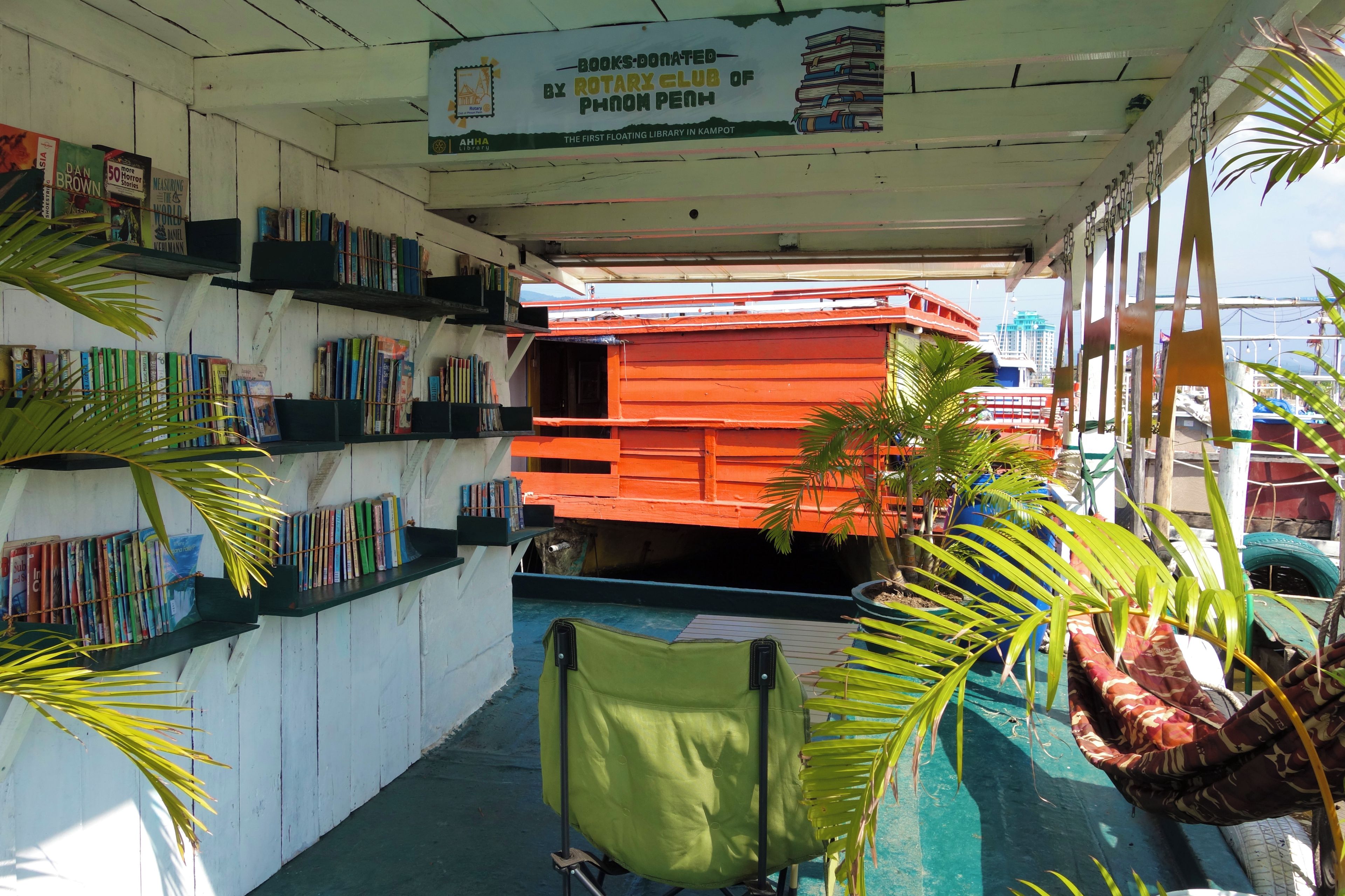 A floating library with bookshelves and a green chair.