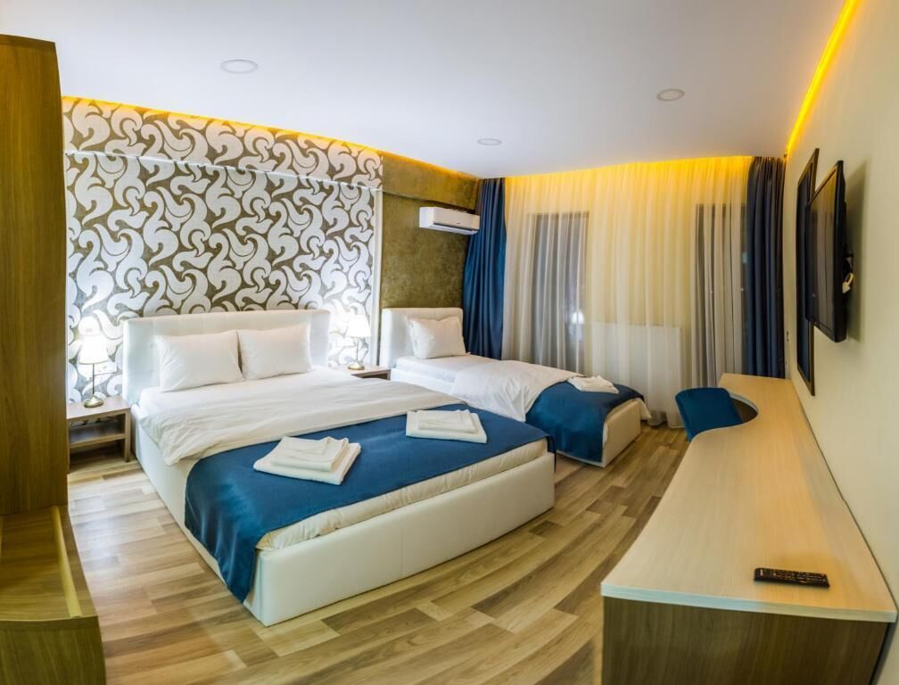 Deluxe Triple Room, City View | In-room safe, desk, blackout drapes, soundproofing