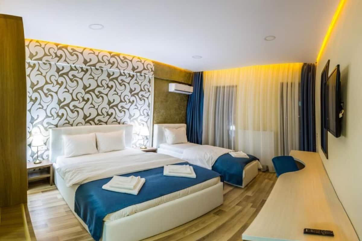 Deluxe Triple Room, City View | In-room safe, desk, blackout drapes, soundproofing