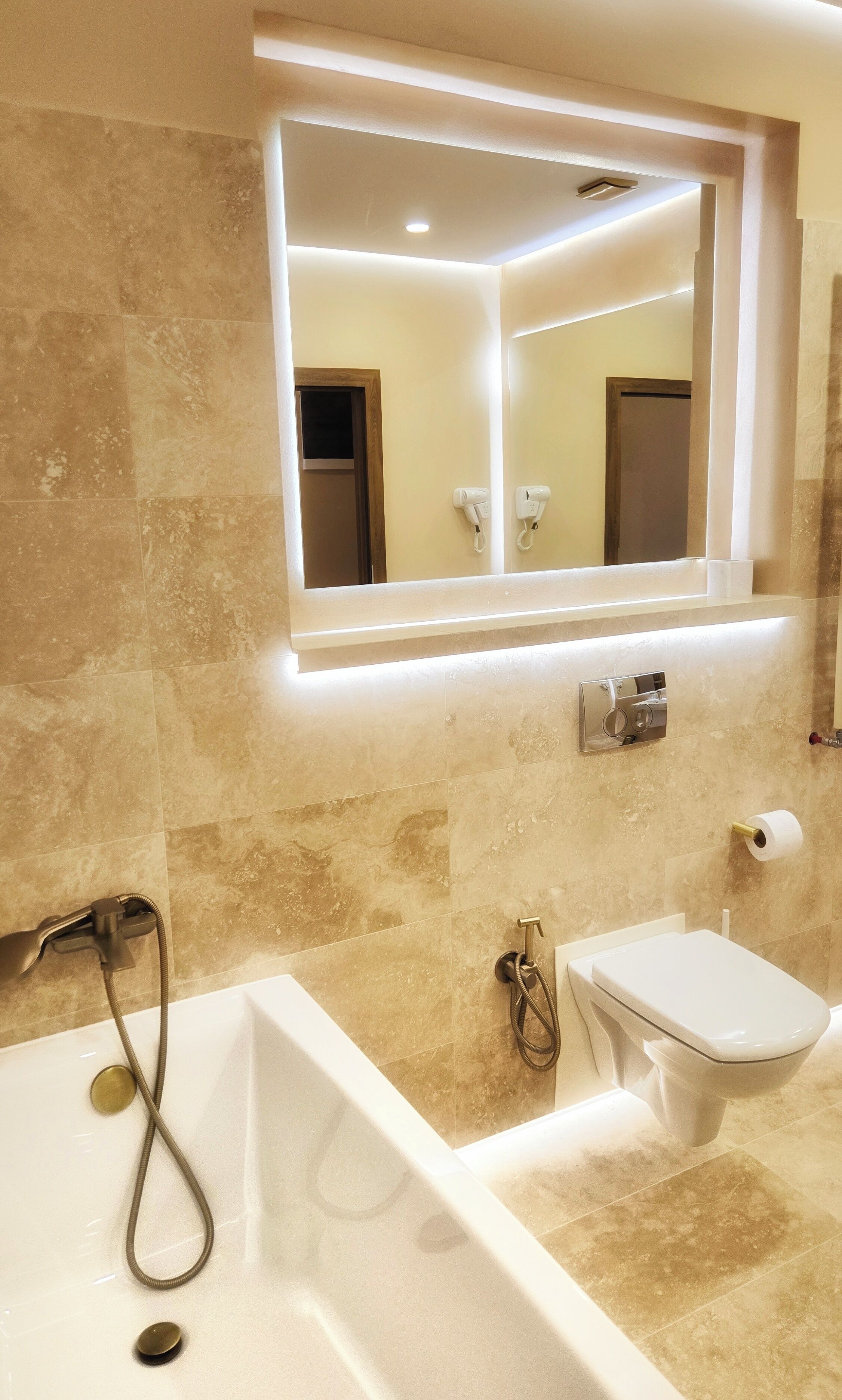 A bathroom with a bathtub, a sink, and a mirror.